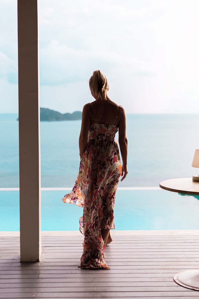 woman-in-flying-summer-dress-at-luxury-hotel-villa-M6J8VZT-683x1024-2.jpg